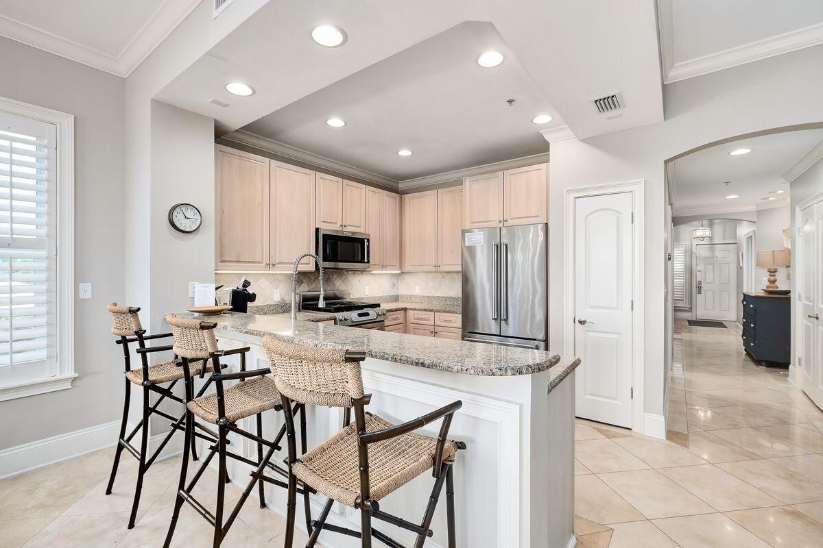 2421 West County Highway 30A, Unit E305 Santa Rosa Beach, FL 32459 - Photo 8 of 39 a kitchen with stainless steel appliances kitchen island granite countertop a refrigerator and microwave