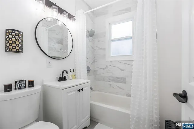 a bathroom with a sink a toilet and a mirror