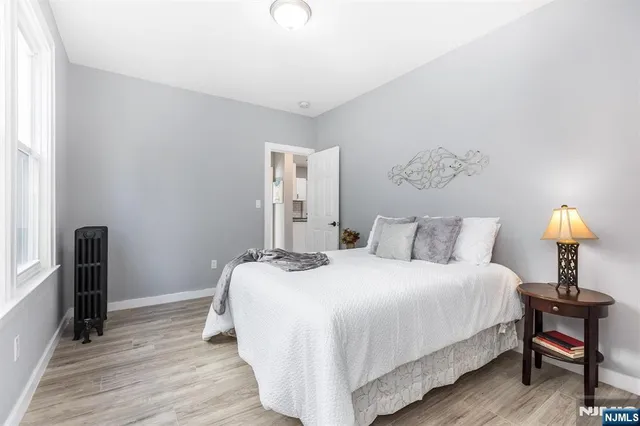 a bedroom with a bed and a lamp