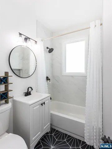a bathroom with a sink a toilet and a mirror