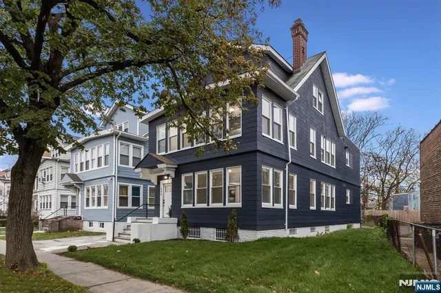 a view of a house with a yard and sitting area