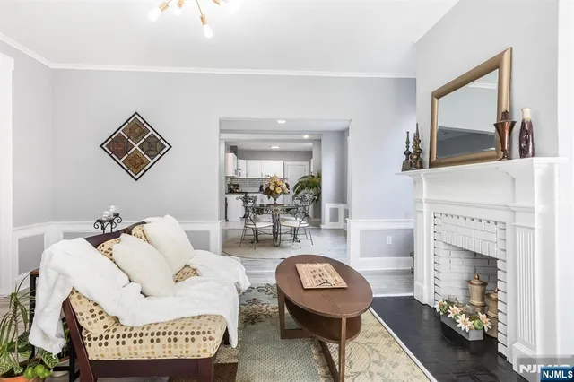 a living room with furniture a rug and a fireplace