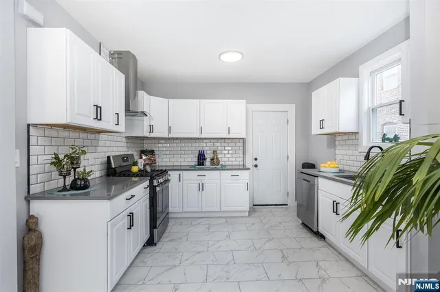 a kitchen with a white cabinets and white appliances