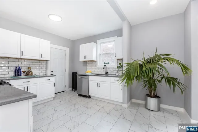 a kitchen with a white stove top oven and cabinets