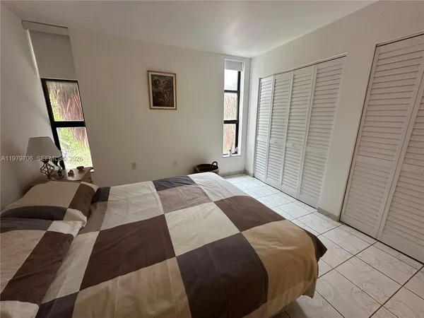 a bedroom with a bed and a mirror
