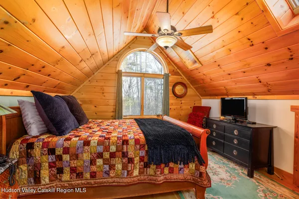a bedroom with furniture and a window