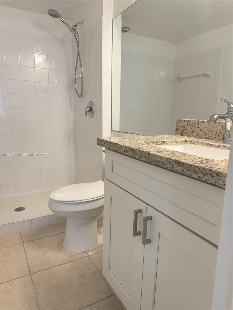 15410 Southwest 284th Street, Unit 8104 Homestead, FL 33033 - Photo 13 of 25 a bathroom with a granite countertop sink a toilet and shower