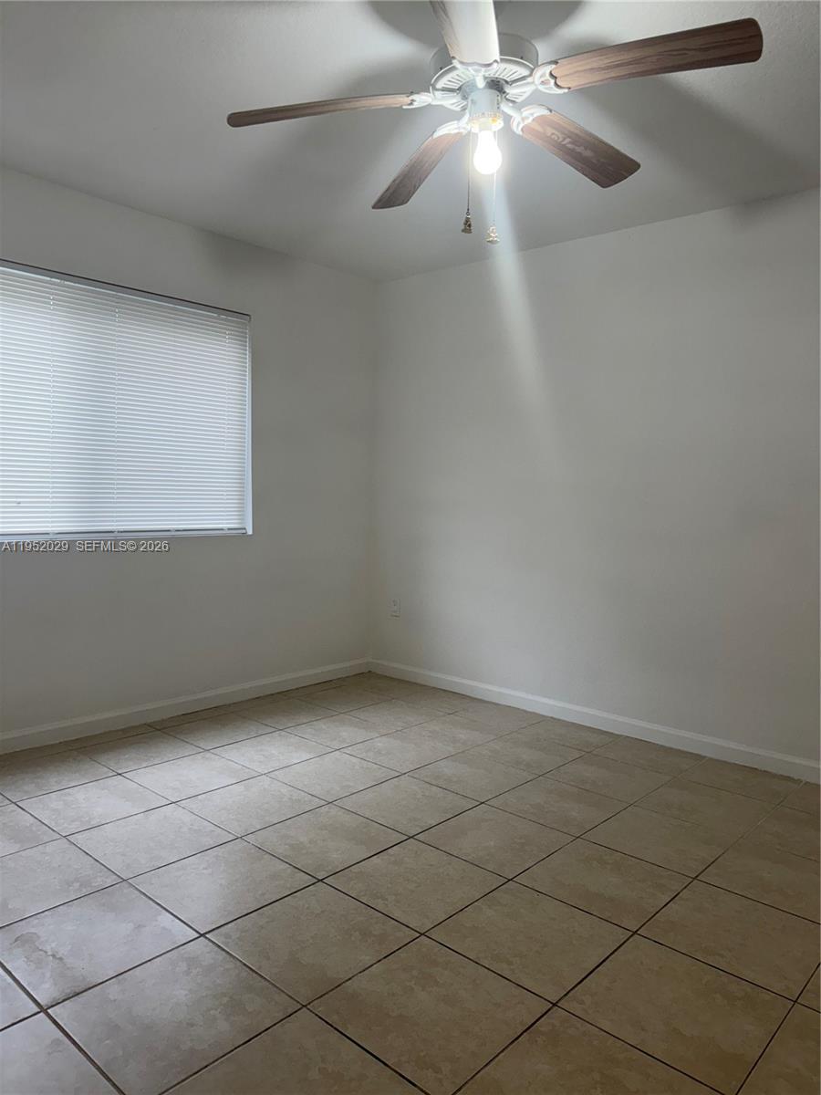 15410 Southwest 284th Street, Unit 8104 Homestead, FL 33033 - Photo 16 of 25 en empty room with windows and ceiling fan