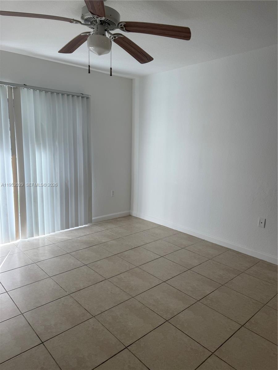 15410 Southwest 284th Street, Unit 8104 Homestead, FL 33033 - Photo 18 of 25 an empty room with fan