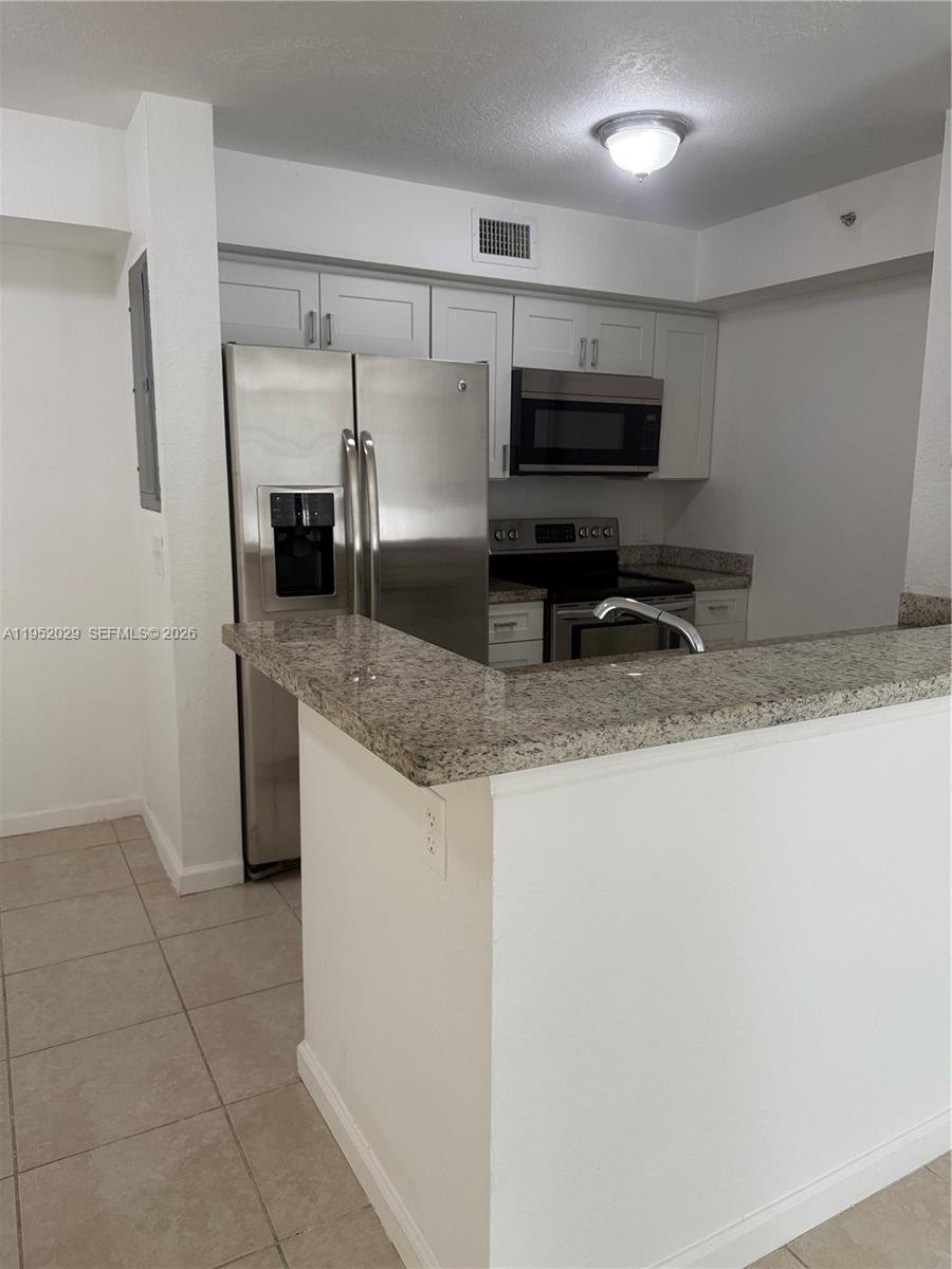 15410 Southwest 284th Street, Unit 8104 Homestead, FL 33033 - Photo 2 of 25 a kitchen with stainless steel appliances granite countertop a sink and a granite counter tops