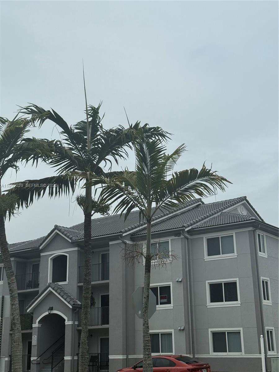 15410 Southwest 284th Street, Unit 8104 Homestead, FL 33033 - Photo 21 of 25 a front view of a house with a garden