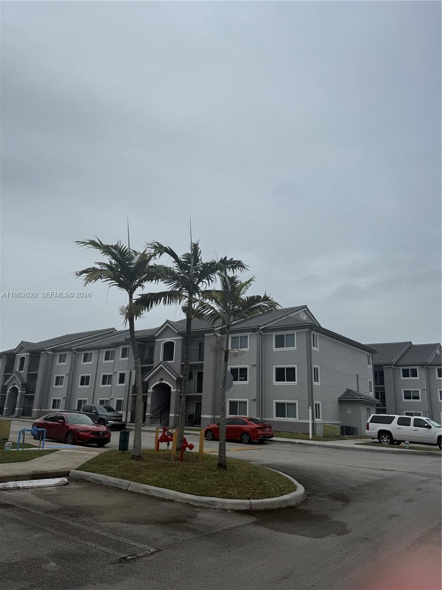15410 Southwest 284th Street, Unit 8104 Homestead, FL 33033 - Photo 22 of 25 a front view of a building with street
