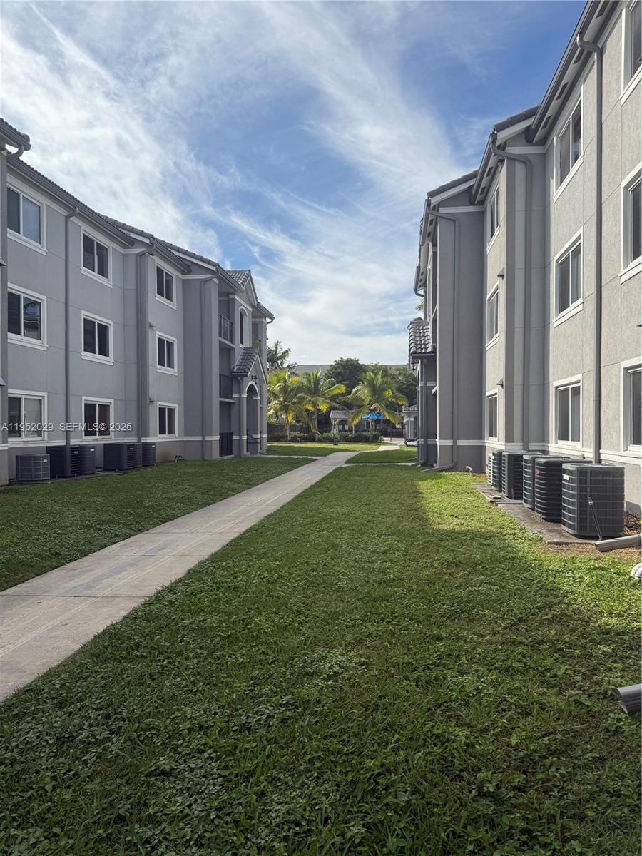 15410 Southwest 284th Street, Unit 8104 Homestead, FL 33033 - Photo 23 of 25 a view of a building with a yard