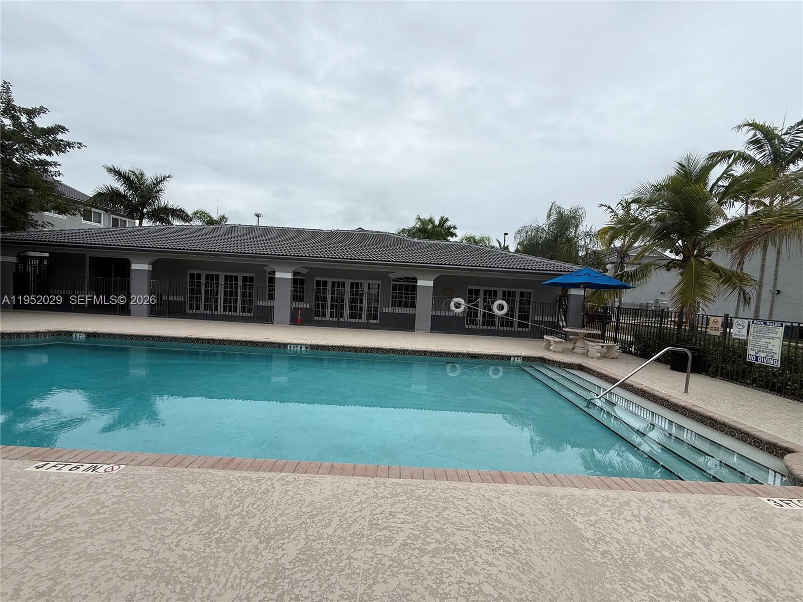 15410 Southwest 284th Street, Unit 8104 Homestead, FL 33033 - Photo 24 of 25 a front view of a house with a garden