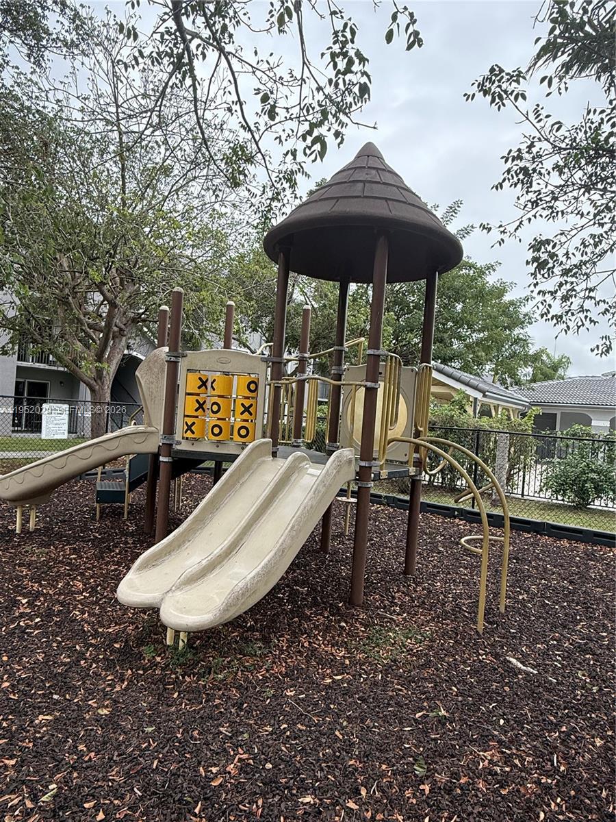 15410 Southwest 284th Street, Unit 8104 Homestead, FL 33033 - Photo 25 of 25 a view of a table and chairs under an umbrella
