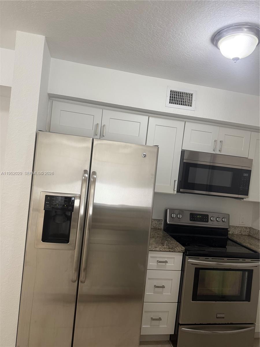 15410 Southwest 284th Street, Unit 8104 Homestead, FL 33033 - Photo 3 of 25 a kitchen with appliances and cabinets