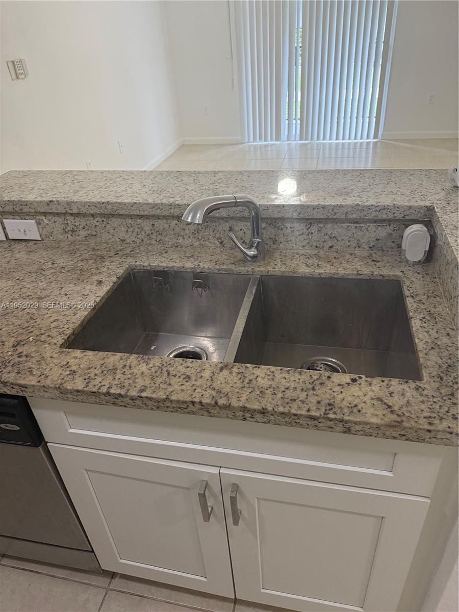 15410 Southwest 284th Street, Unit 8104 Homestead, FL 33033 - Photo 4 of 25 a kitchen with a sink and granite counter top