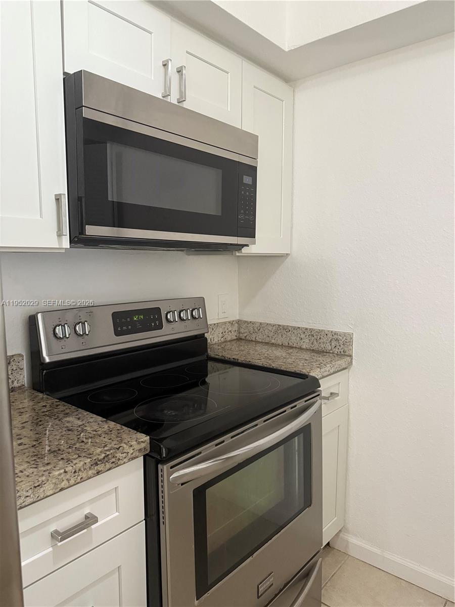 15410 Southwest 284th Street, Unit 8104 Homestead, FL 33033 - Photo 6 of 25 a stove top oven sitting inside of a kitchen