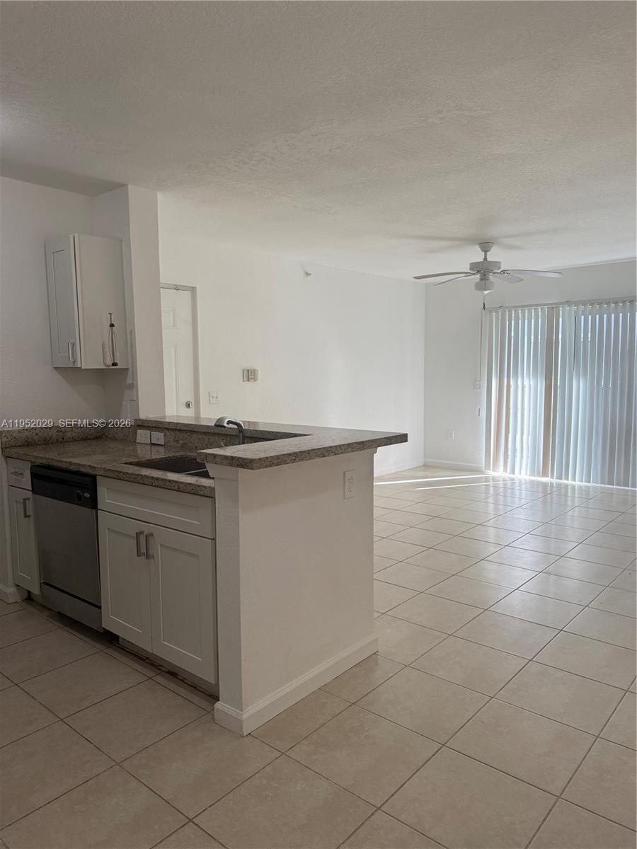 15410 Southwest 284th Street, Unit 8104 Homestead, FL 33033 - Photo 7 of 25 a kitchen with granite countertop a sink and a stove