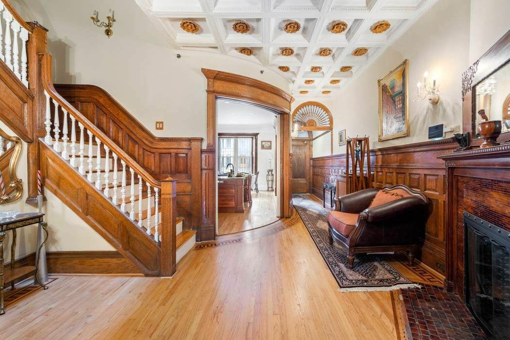 a living room with furniture a fireplace and a wooden floor
