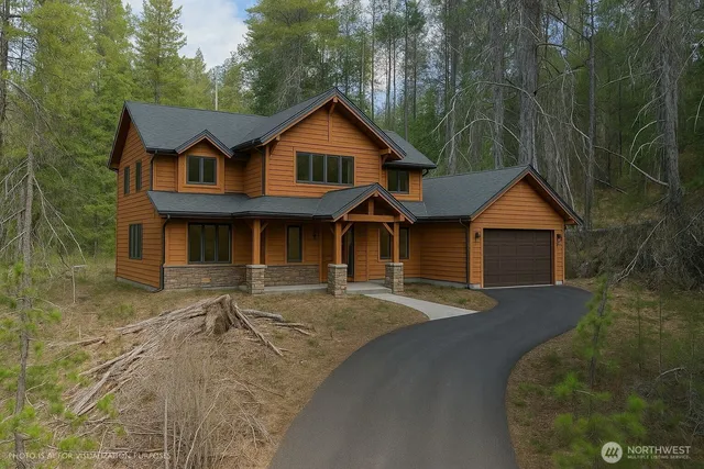 a front view of a house with yard and parking