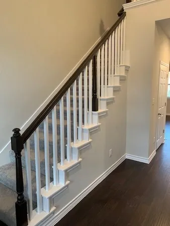 a view of staircase with wooden floor and a window