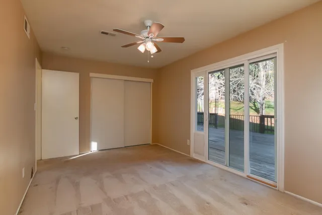 a view of an empty room with glass door
