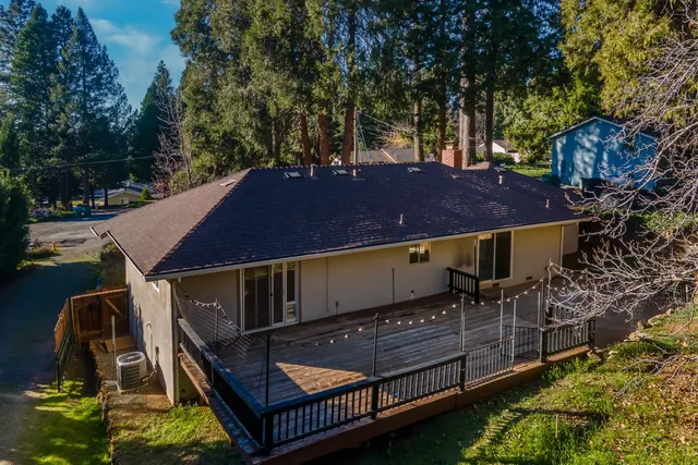 a view of a roof deck with couches and wooden floor