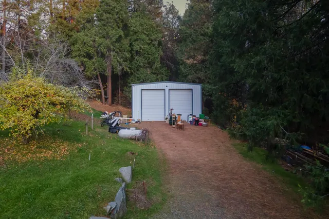 a backyard of a house with table and chairs