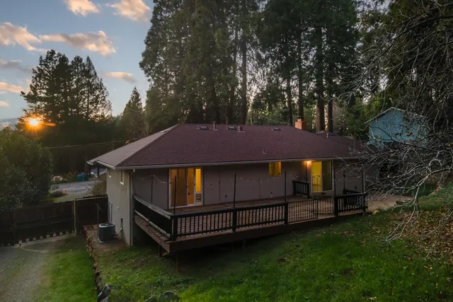 a backyard of a house with yard and trampoline