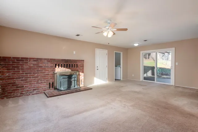 a view of an empty room with a fireplace
