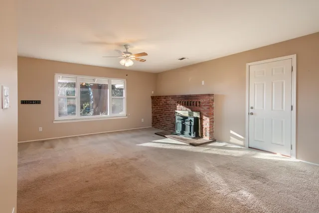 a view of an empty room with a fireplace