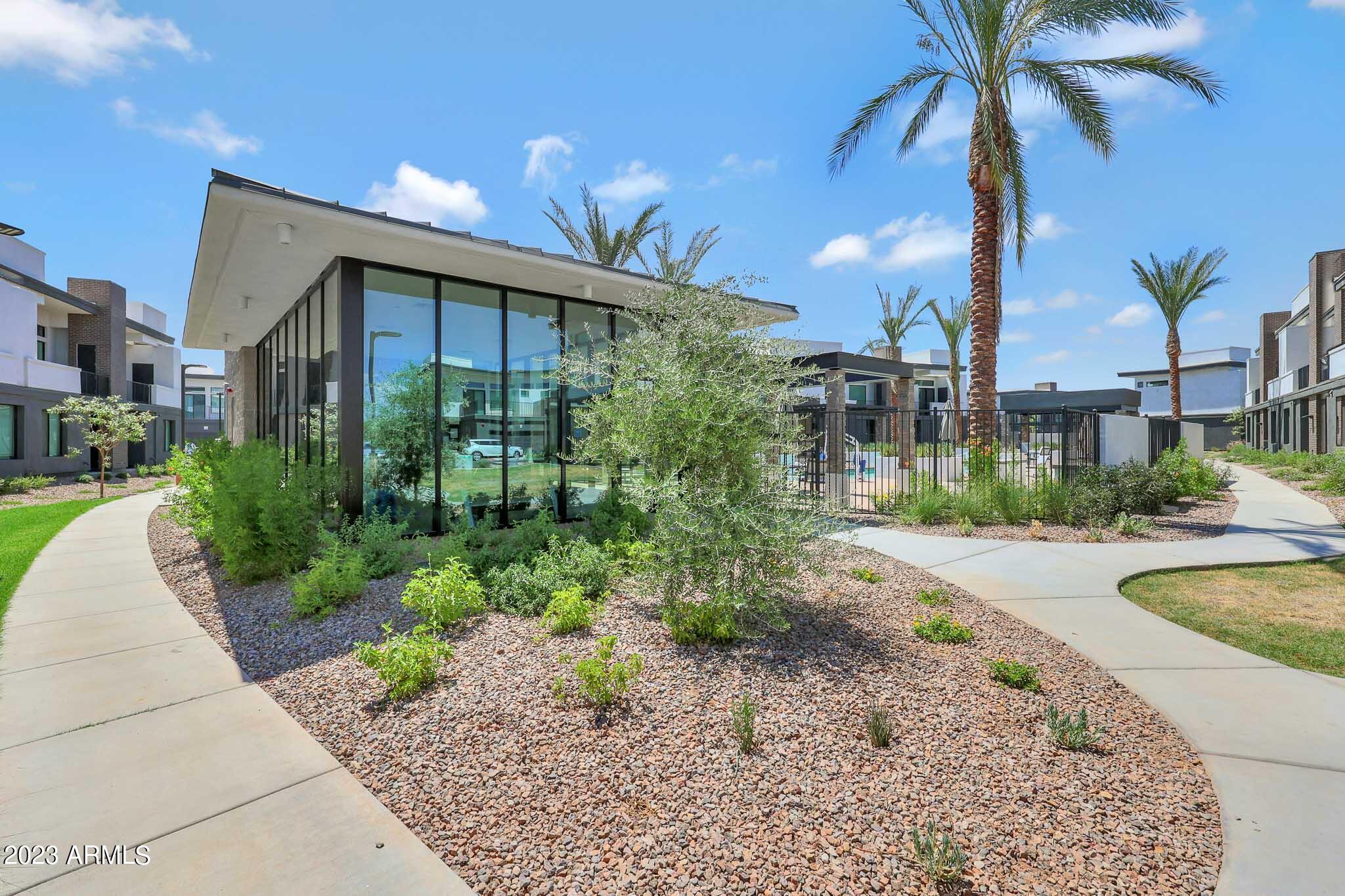 6060 East Baseline Road, Unit 151 Mesa, AZ 85206 - Photo 1 of 45 a front view of a house with a yard