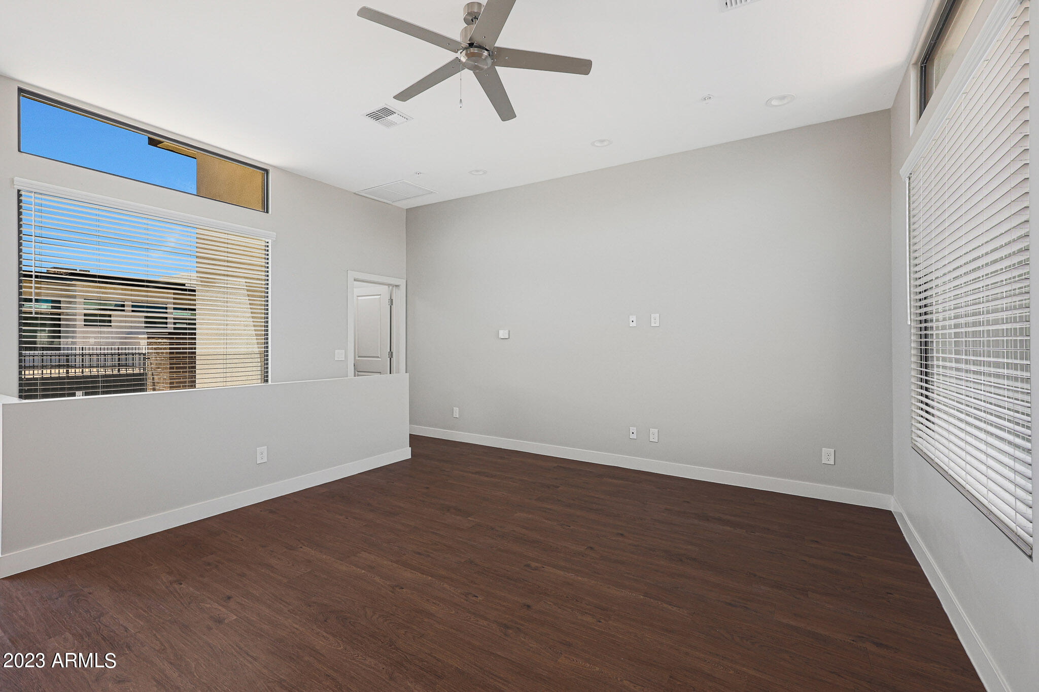 6060 East Baseline Road, Unit 151 Mesa, AZ 85206 - Photo 22 of 45 a view of an empty room with wooden floor and a window
