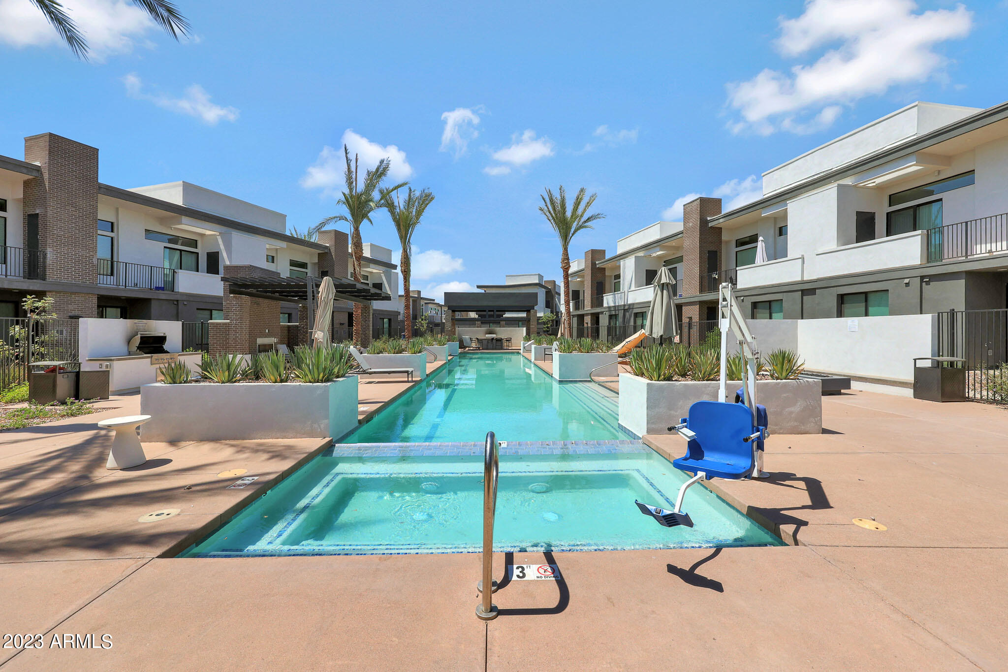 6060 East Baseline Road, Unit 151 Mesa, AZ 85206 - Photo 34 of 45 a house view with pool and chairs
