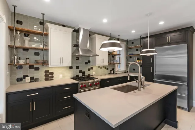 a kitchen with a sink a stove a refrigerator and chairs