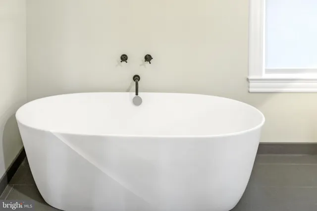 a white bath tub sitting in a bathroom