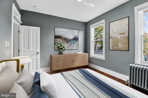 a bedroom with a bed and wooden floor