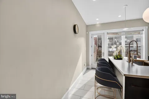 a hallway with a large mirror and sink