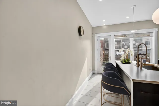 a hallway with a large mirror and sink