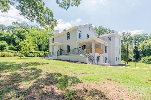 a front view of house with yard and green space