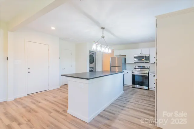 a kitchen with granite countertop a sink and cabinets