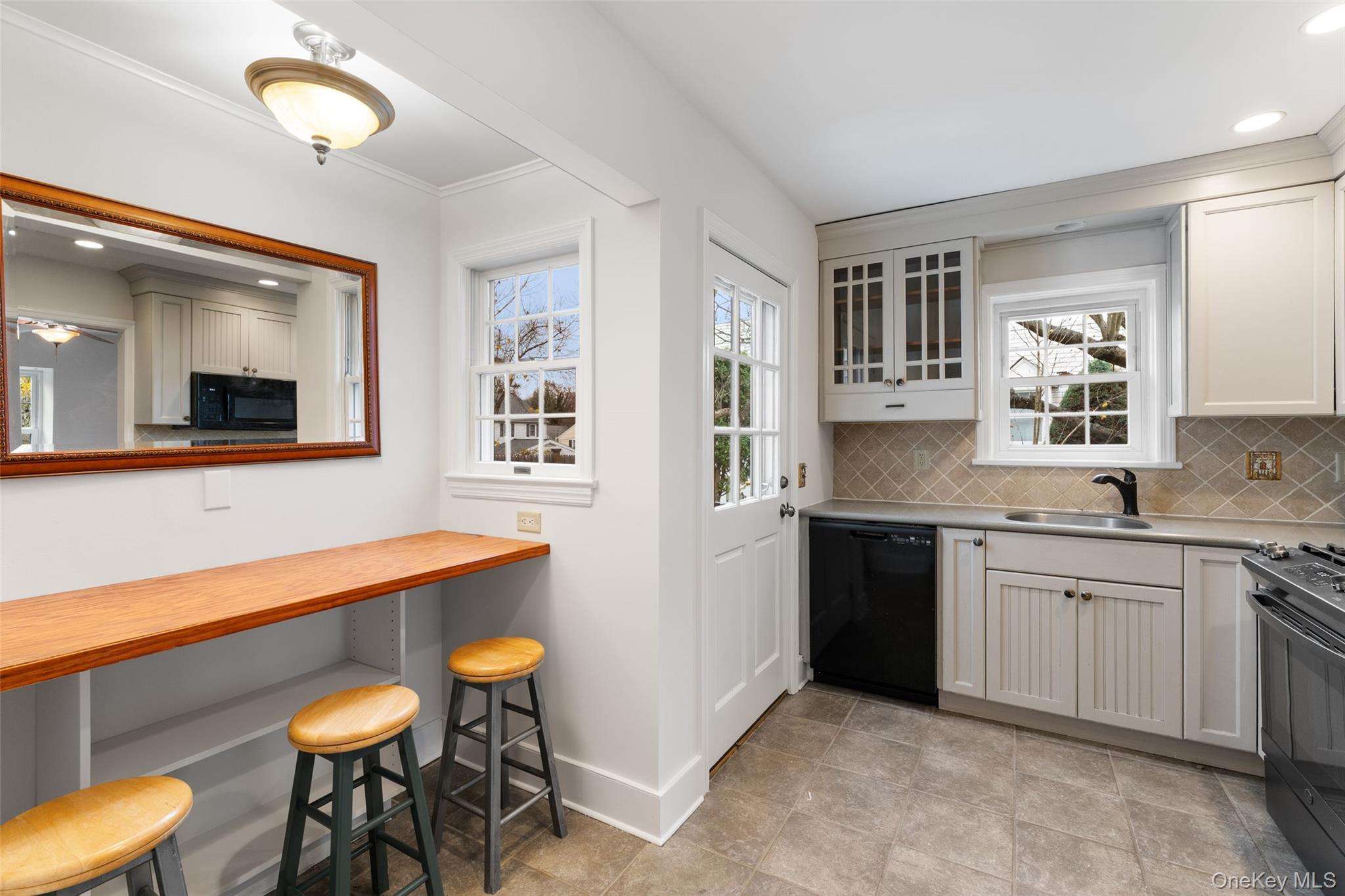 1 Winslow Circle Tuckahoe, NY 10707 - Photo 11 of 30 a kitchen with stainless steel appliances granite countertop a sink and a wooden cabinets