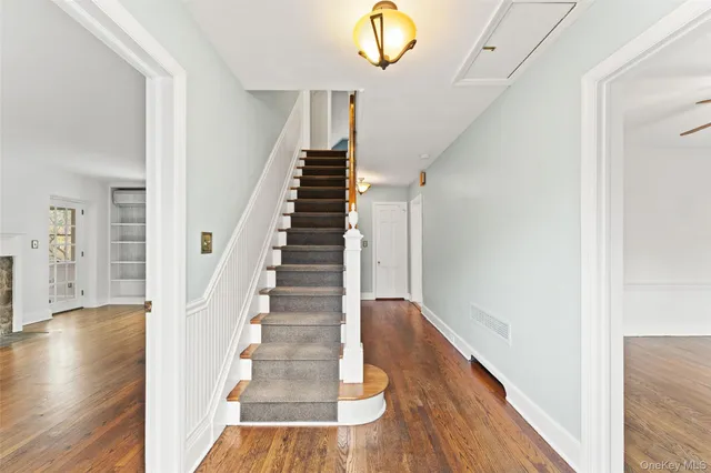 a view of entryway and hall with wooden floor