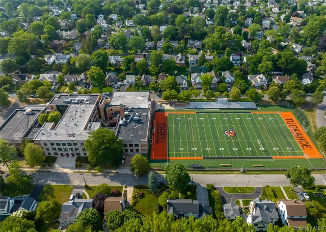 an aerial view of a house with a yard