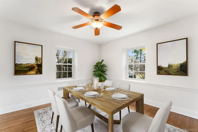 a view of a dining room with furniture window and wooden floor