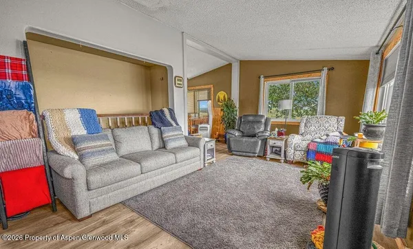 a living room with furniture and a floor to ceiling window