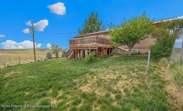 a view of a house with a yard and balcony