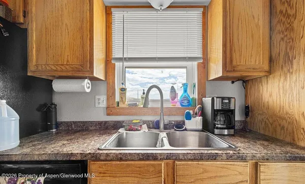 a kitchen with granite countertop a sink and a window