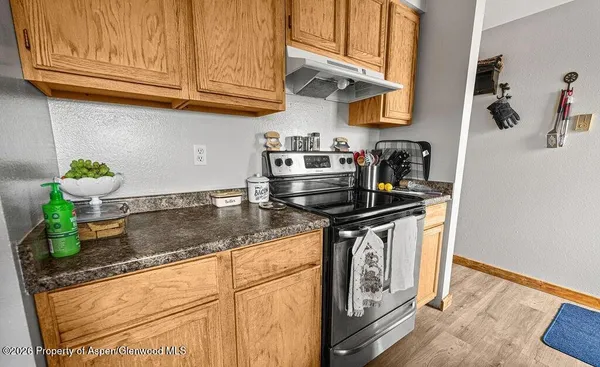 a kitchen with stainless steel appliances granite countertop a sink a stove and cabinets